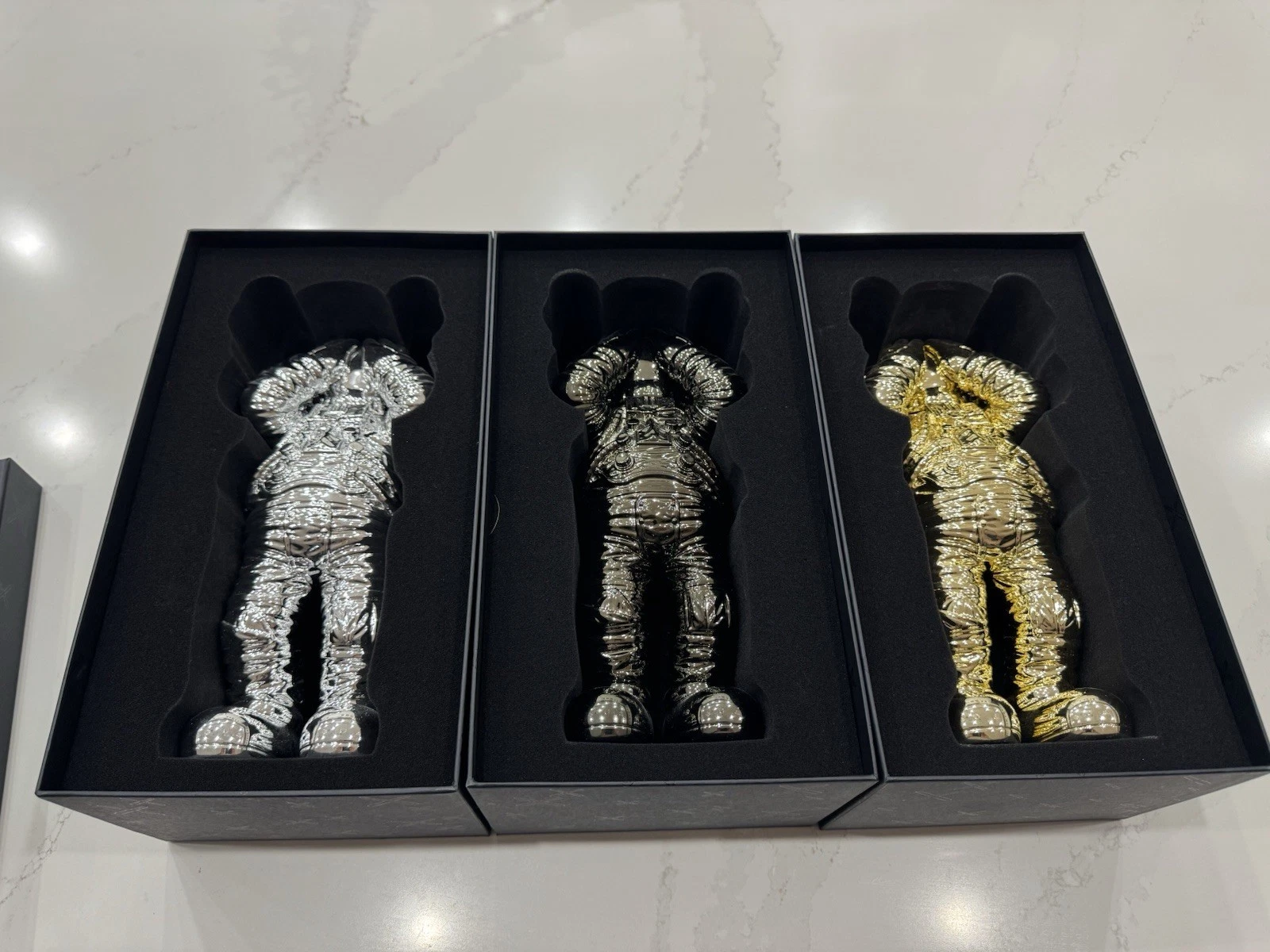 KAWS HOLIDAY SPACE FIGURE SET (GOLD SILVER & BLACK)- COMPLETE SET OF 3 FIGURES