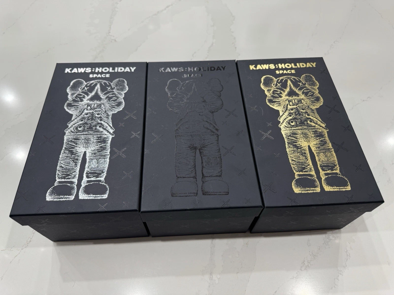 KAWS HOLIDAY SPACE FIGURE SET (GOLD SILVER & BLACK)- COMPLETE SET OF 3 FIGURES
